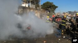 Iraqi firefighters distinguish a fire at the scene of a bomb attack in Kirkuk, 180 miles (290 kilometers) north of Baghdad, Iraq, February 3, 2013.