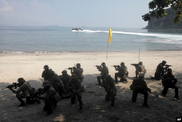 FILE - U.S. Marines from the 3rd Marine Expeditionary Brigade and the 31st Marine Expeditionary Unit and Philippine marines take their positions as they take part in a boat raid exercise during their joint military exercise, dubbed PHIBLEX 2016.