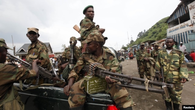 Congolese rebels sit in a truck as they patrol a street in Sake, 25 kilometers north of Goma city soon after the rebels captured the town from the government army, in the eastern Democratic Republic of Congo, November 21, 2012.