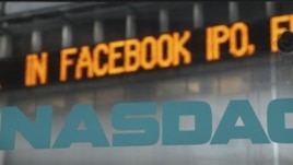 News about the Facebook IPO passes on a billboard outside of NASDAQ in Times Square, New York, May 15, 2012.