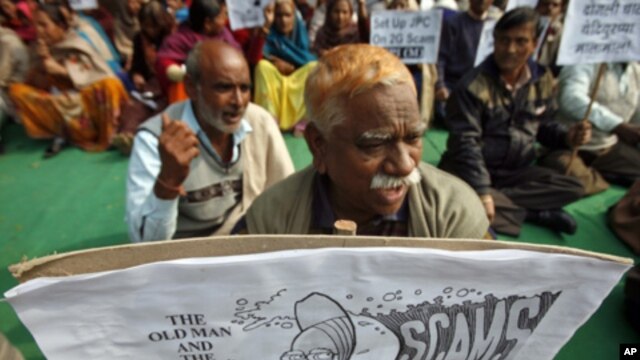 Activists of Communist Party of India Marxist CPI hold a cartoon placard portraying Indian Prime Minister Manmohan Singh during a protest against the telecom corruption scandal, New Delhi 10 Dec. 2010.