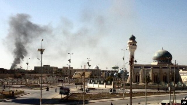 A plum of smoke is seen following a wave of attacks prior to the storming a police compound in the western Iraqi city of Ramadi, January 15, 2012.
