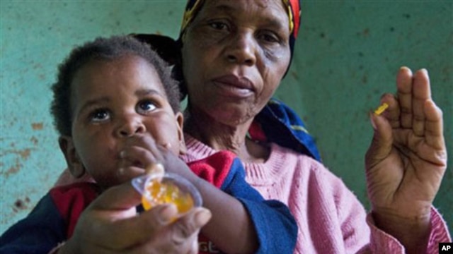HIV positive child is given some jam prior to her ARV, near Durban, South Africa, 30 Nov 2010