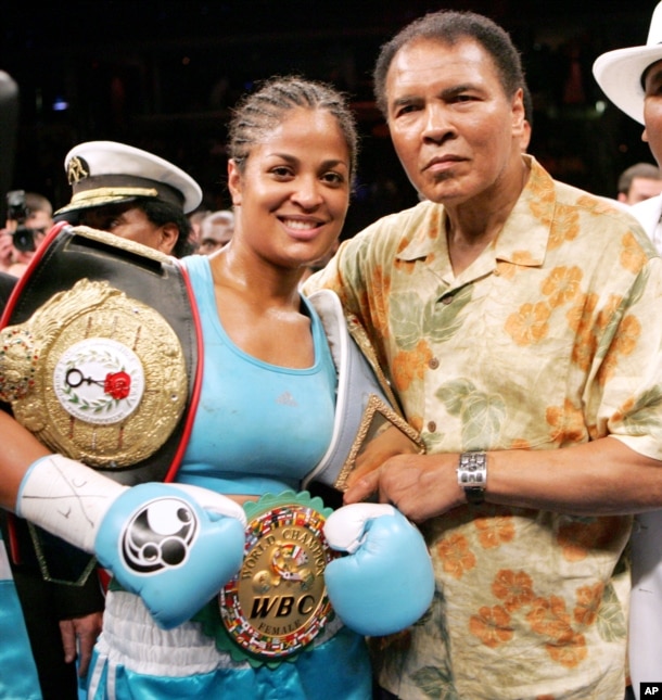 FILE - Laila Ali, left, poses with her father, boxing great Muhammad Ali, after her win against Erin Toughill at the MCI Center in Washington, June 11, 2005.