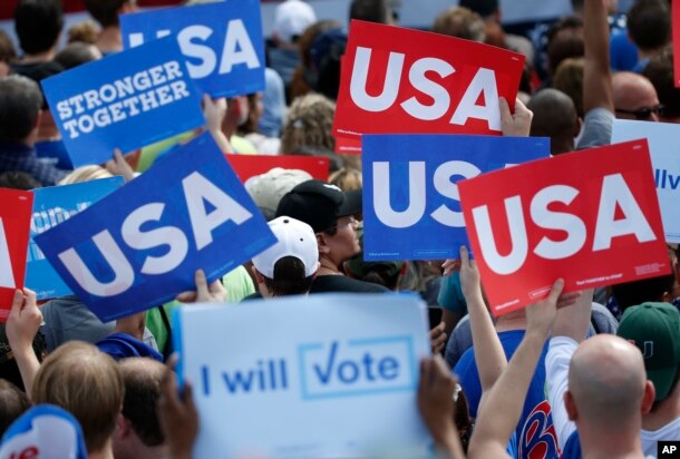 Supporters of Democratic presidential candidate Hillary Clinton hold up signs at a rally, Nov. 5, 2016, in Pembroke Pines, Fla