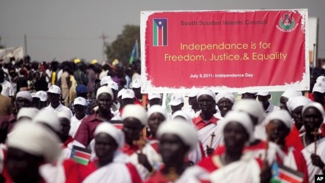 Southern Sudanese march and carry signs during a rehearsal for independence celebration, in the southern capital of Juba on Tuesday, July 5, 2011