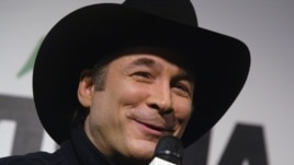 Grammy Award winner Clint Black talks with reporters prior to the start of the Daytona 500 at the Daytona International Speedway in Daytona Beach, Fla., on Feb. 20, 2005.