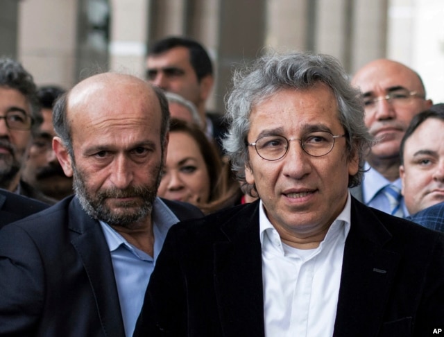 FILE - Can Dundar, right, the editor-in-chief of opposition newspaper Cumhuriyet, and Erdem Gul, left, the paper's Ankara representative, speak to the media outside a courthouse in Istanbul, Turkey, Nov. 26, 2015.