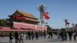 A U.S. flag is displayed beside a Chinese flag as tourists flock outside the Forbidden City in Beijing, Nov. 12, 2014. 