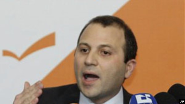 Lebanese Energy Minister Jibran Bassil announces the resignation of Hezbollah ministers and their allies during a press conference in the northern Beirut suburb of Rabieh, 12 Jan 2011