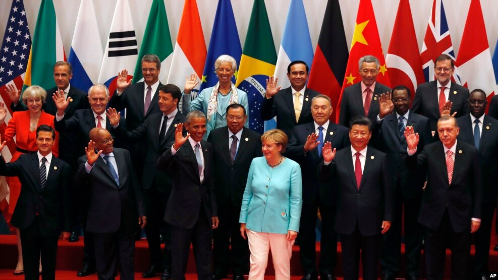 U.S. President Barack Obama, front row third from left, Chinese President Xi Jinping, second from right, and other leaders wave as they pose for a group photo session for the G-20 Summit held at the Hangzhou International Expo Center.