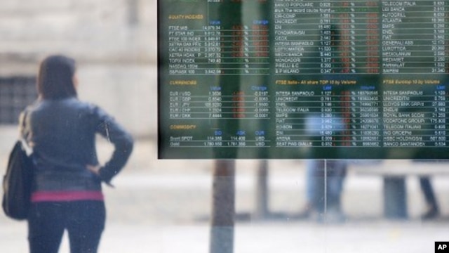 A stock exchange monitor displays the market trends in Milan, Italy, November 9, 2011.
