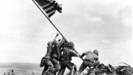 Joe Rosenthal's photo of Marines of the 28th Regiment of the Fifth Division raising the American flag atop Mount Suribachi, Iwo Jima, on February 23, 1945