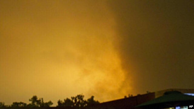 Sky over Tripoli, Libya, is illuminated by explosions during an airstrike, early Tuesday, May 24, 2011