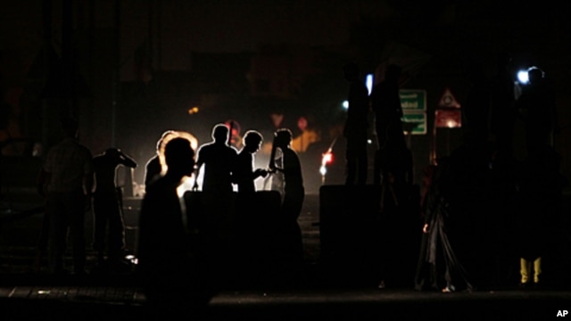 Anti-government protesters chant slogans behind makeshift barriers in the western Shi'ite village of Malkiya, Bahrain, October 6, 2011.
