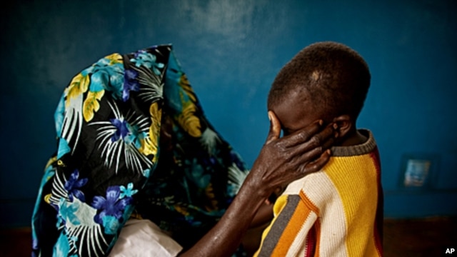 A mass rape victim comforts her son in the town of Fizi, Democratic Republic of Congo, February 20, 2011