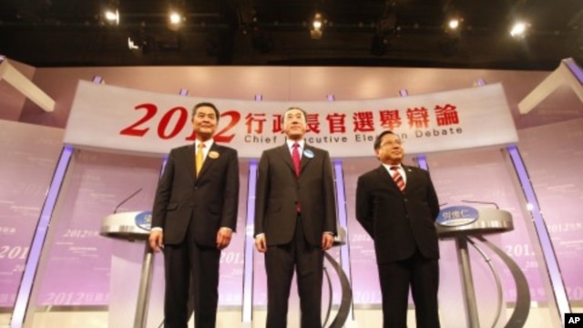 Hong Kong Chief Executive candidates (L-R) Leung Chun-ying, Henry Tang and Albert Ho stand on the stage after a live television debate in Hong Kong, March 16, 2012.