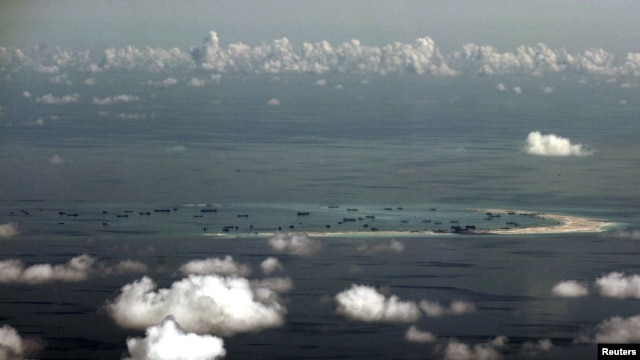 FILE - An aerial photo taken though a glass window of a Philippine military plane shows the alleged ongoing land reclamation by China on mischief reef in the Spratly Islands in the South China Sea, west of Palawan, Philippines.