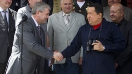 Venezuela's President Hugo Chavez (R) and First Deputy Prime Minister of Belarus Vladimir Semashko shake hands after their meeting at Miraflores Palace in Caracas, Venezuela, June 2, 2012.