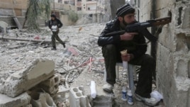 A Free Syrian Army fighter is seen taking a breakfast break during heavy fighting in Mleha suburb of Damascus January 25, 2013.