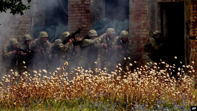 FILE - Georgian soldiers take part in a joint NATO-Georgia exercise at a military base in Vaziani, outside Tbilisi, Georgia, July 21, 2015.