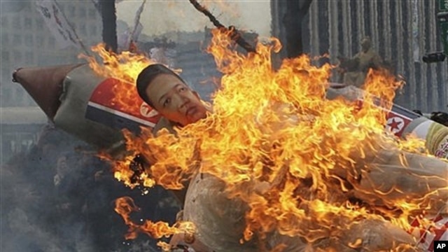 Effigy of North Korea's Kim Jong Un on burning mock missile at Seoul protest, South Korea, April 13, 2012.