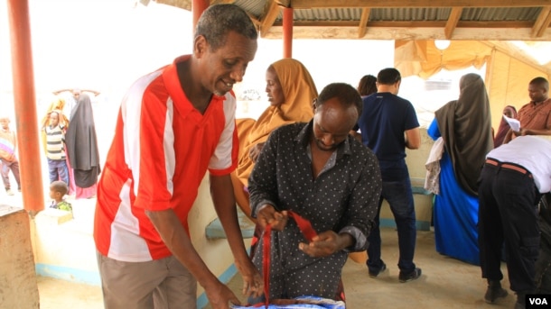 Workers help refugees check-in for repatriation flight to Mogadishu, Dadaab, Kenya, September 21, 2016.