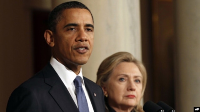 U.S. President Barack Obama with U.S. Secretary of State Hillary Clinton (right) speaks about Libya at the White House,. February 23, 2011
