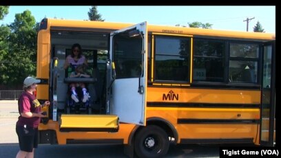 A Metropolitan Transportation Network bus picks up students for summer school in Minnesota, Aug. 8, 2017.
