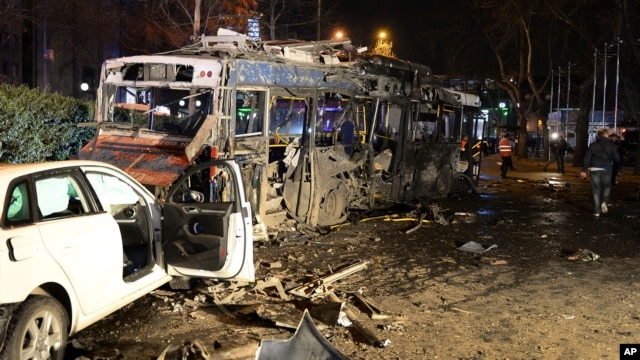 Damaged vehicles are seen at the scene of an explosion in Ankara, Turkey, Sunday, March 13, 2016.