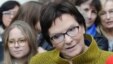 Polish Prime Minister Ewa Kopacz of the Civic Platform party speaks with journalists after meeting with a group of women in Warsaw, Oct. 23, 2015, on the last day of campaigning before Sunday's parliamentary elections.