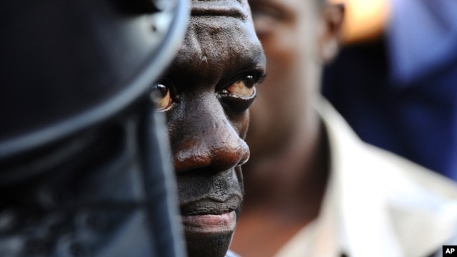 Uganda's Forum for Democratic Change leader Kizza Besigye is arrested by anti-riot policemen at the Kasangati suburb of Kampala, April 14. (Reuters)