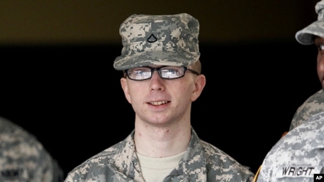 In this file photo taken Dec. 22, 2011, Army Pfc. Bradley Manning is escorted from a courthouse in Fort Meade, Maryland. 