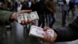 FILE - Iranian street money exchangers show currencies at Tehran's old main bazaar, Iran.