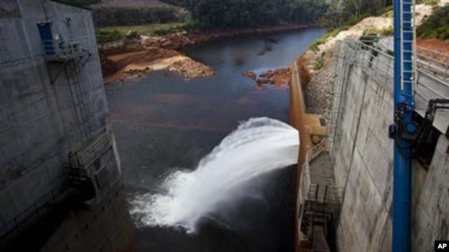 In this photo taken on Oct. 24, 2010, the Nam Theun 2 dam on the Nam Theun river, a tributary of the Mekong river, in central Laos releases water to the river below. One month earlier, on September 22, 2010, Laos officially submitted its proposal for the 