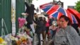 A woman views floral tributes to Drummer Lee Rigby, of the British Army