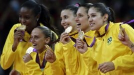 Members of the Brazil women's volleyball team show off their gold medals following a 3-1 win over the United States during the women's gold medal volleyball match at the 2012 Summer Olympics, Saturday, Aug. 11, 2012, in London. 