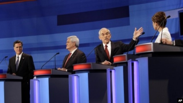 Republican presidential candidates from left, former Massachusetts Gov. Mitt Romney, former House Speaker Newt Gingrich, Rep. Ron Paul, R-Texas, and Rep. Michele Bachmann, R-Minn., participate in a Republican presidential debate in Sioux City, Iowa, Dec. 