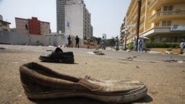 Abandoned shoes litter a street in Plateau district where a stampede occurred after a New Year's Eve fireworks display, Abidjan, Jan. 1, 2013.