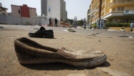 Abandoned shoes litter a street in Plateau district where a stampede occurred after a New Year's Eve fireworks display, Abidjan, Jan. 1, 2013.