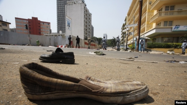 Abandoned shoes litter a street in Plateau district where a stampede occurred after a New Year's Eve fireworks display, Abidjan, Jan. 1, 2013.