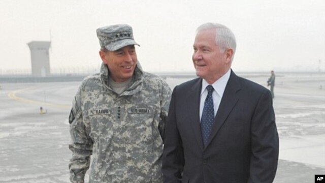 General Petraeus, Commander of ISAF Afghanistan, chats with US Defense Secretary Gates upon Gates' arrival in Kabul, March 7, 2011