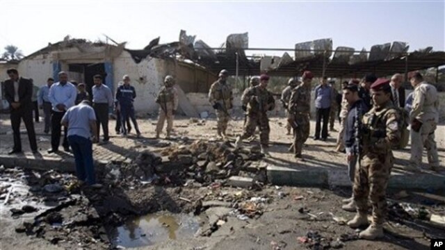 Iraqi security forces inspect the scene of a car bomb attack in Karbala, 50 miles (80 kilometers) south of Baghdad, 8 Nov. 2010.