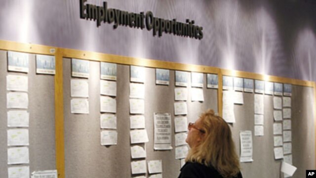 Lori Kamlet looks at posted employment opportunities at a Denver Employment office on Friday, July 22, 2011