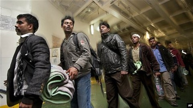 Some of the 1,200 migrant workers who were evacuated from Misrata by boat, many suffering from dehydration and needing medical attention, leave the boat after it arrived at the port in Benghazi, Libya, April 15, 2011