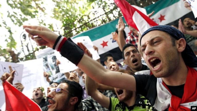 Demonstrators chant slogans during a protest demanding the ouster of the Syrian government, in front of the Syrian embassy in Cairo April 26, 2011