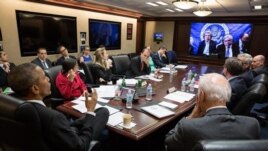 U.S. President Barack Obama, left, receives an update Wednesday in the Situation Room from Secretary of State John Kerry.