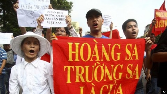 Vietnamese protesters carry a banner with a Vietnamese slogan reading, "Paracel islands and Spratly islands belong to Vietnam," during a protest demanding China to stay out of their waters following China's increased activities around the Spratly Islands 