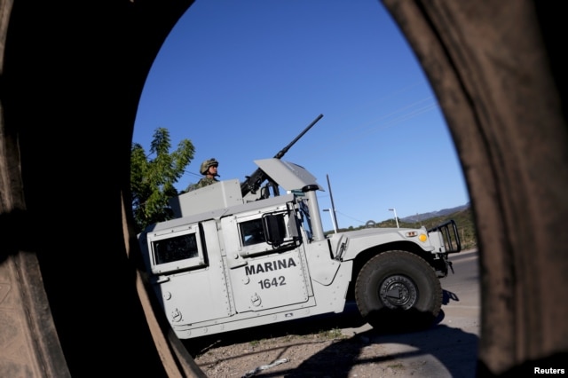 A soldier mans his machine gun atop an armored vehicle in a checkpoint at the hometown of Joaquin "El Chapo" Guzman in the municipality of Badiraguato, in Sinaloa state, Mexico, Jan. 9, 2016.