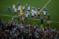 Argentina soccer players celebrate with fans after defeating the Netherlands during a World Cup semifinal soccer match at the Itaquerao Stadium in Sao Paulo. Argentina reached the World Cup final on Wednesday after beating the Netherlands 4-2 in a penalty shootout. 